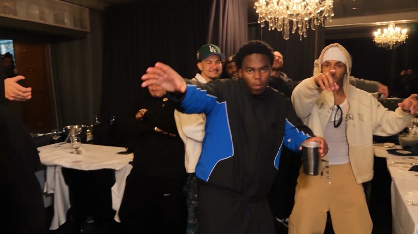 Burning Bridges AI AI party video reference: guests in blue sports jerseys dancing at a party.