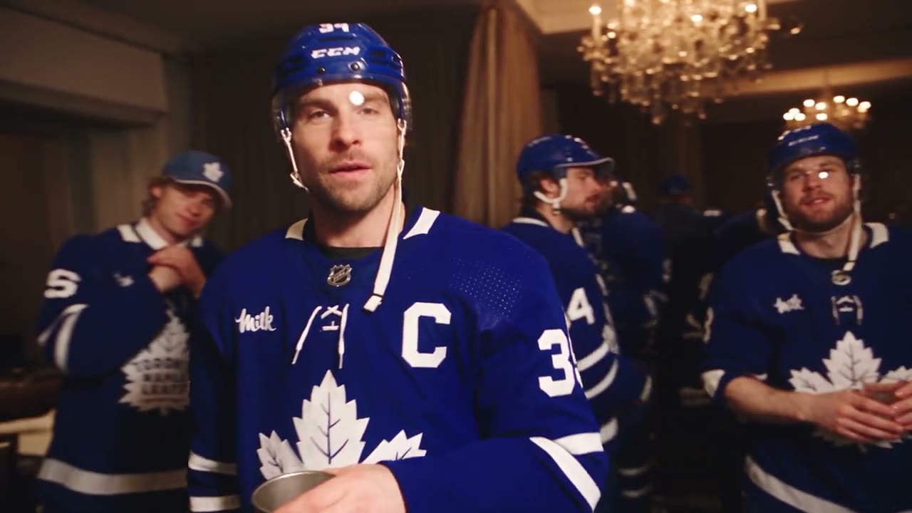 Burning Bridges AI AI party video reference: friends in hockey jerseys dancing at an indoor party.